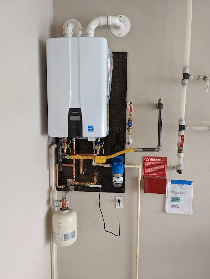 Professional plumber installing copper piping in a Laurinburg home